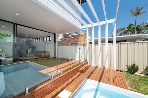Freshly painted exterior pergola and deck area with glass balustrade