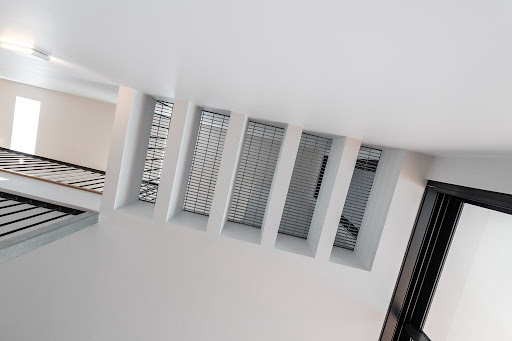 Interior ceiling and wall detail with crisp white finish and deep window reveals
